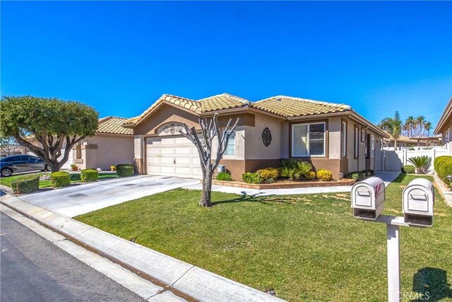 mediterranean / spanish house with stucco siding, an attached garage, a front yard, driveway, and a tiled roof