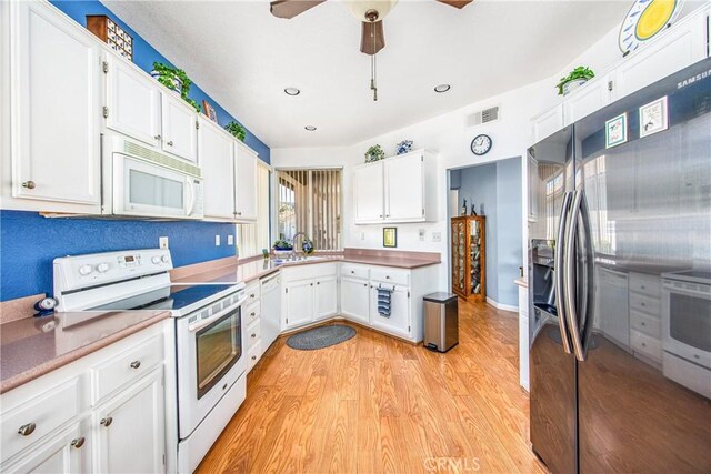 kitchen featuring visible vents, light wood-style flooring, a ceiling fan, white cabinetry, and white appliances