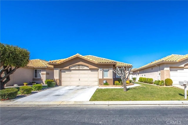 view of front of home featuring driveway, a tiled roof, an attached garage, a front lawn, and stucco siding