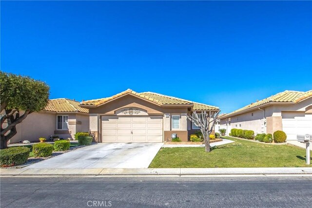 5855 Myrtle Beach Dr, Banning, CA 92220 - mediterranean / spanish home with an attached garage, stucco siding, a front yard, concrete driveway, and a tiled roof