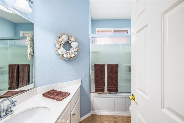 full bath with shower / bath combination with glass door, tile patterned flooring, and vanity