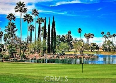 view of community featuring a water view, golf course view, and a lawn