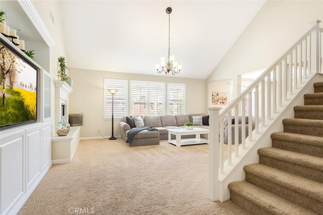 living area with stairs, high vaulted ceiling, a notable chandelier, and light colored carpet