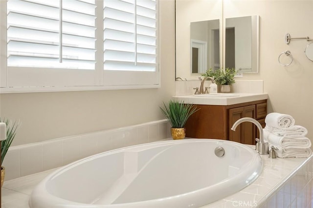 full bath featuring a bath and vanity