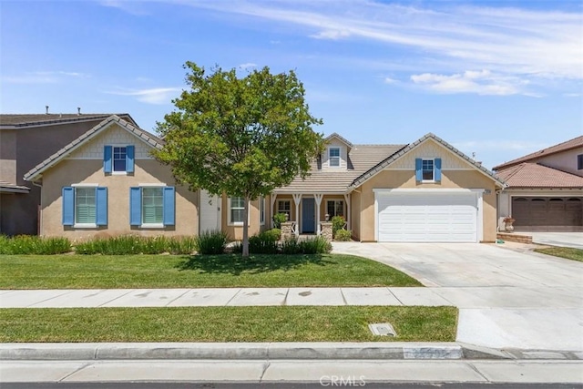 view of front of home featuring an attached garage, a tile roof, concrete driveway, stucco siding, and a front yard