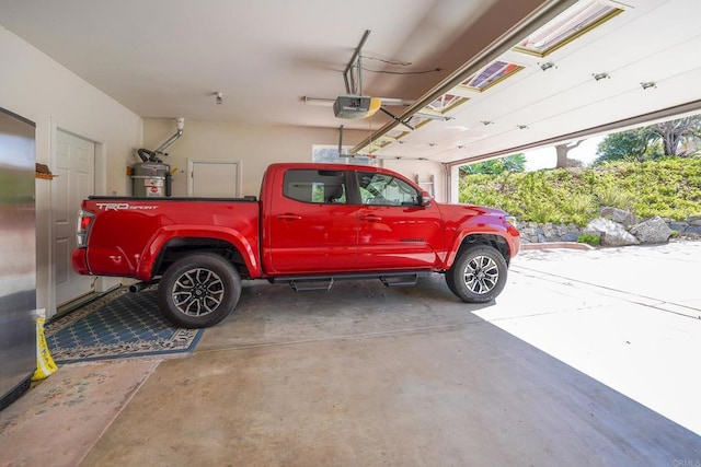 garage featuring a garage door opener and secured water heater