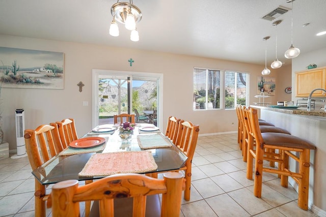 dining space with plenty of natural light, visible vents, baseboards, and light tile patterned flooring