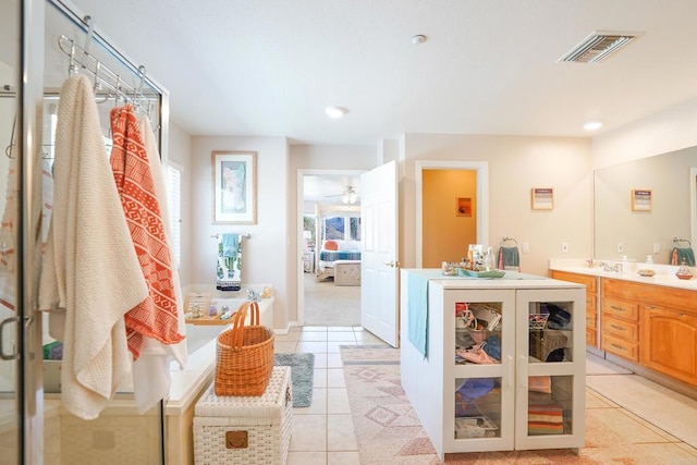 ensuite bathroom featuring tile patterned flooring, visible vents, vanity, and ensuite bathroom