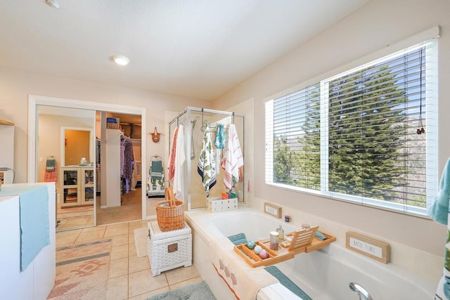 bathroom with a garden tub, a shower stall, vanity, and tile patterned floors