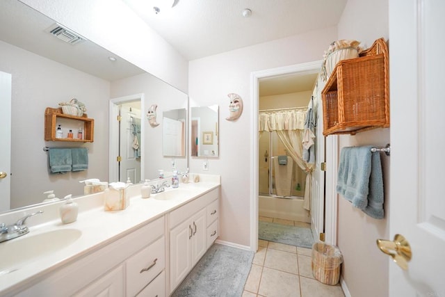 full bathroom with double vanity, a sink, visible vents, and tile patterned floors