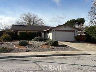 view of front facade with concrete driveway and an attached garage