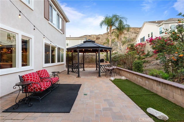 view of patio / terrace featuring a mountain view and a gazebo
