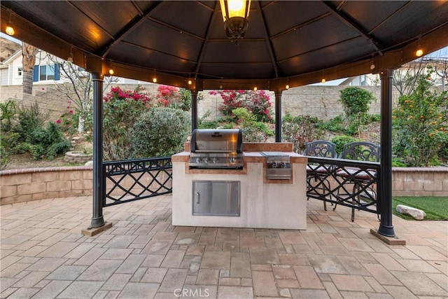 view of patio featuring area for grilling, a grill, and a gazebo