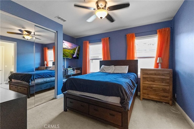 bedroom with carpet, a closet, visible vents, ceiling fan, and baseboards