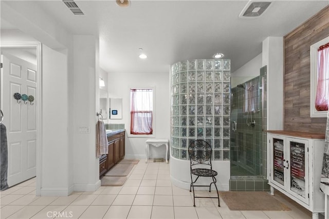 bathroom featuring a stall shower, visible vents, tile patterned flooring, vanity, and a freestanding tub