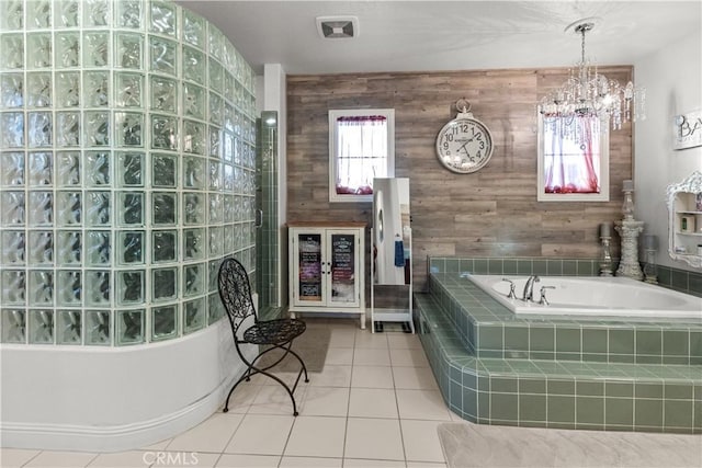 bathroom featuring wood walls, a bath, and tile patterned floors