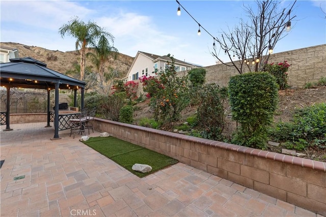 view of patio / terrace featuring fence and a gazebo