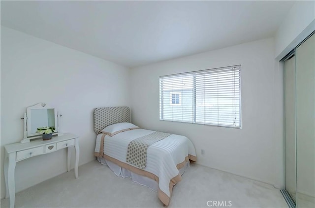 bedroom with carpet and a closet