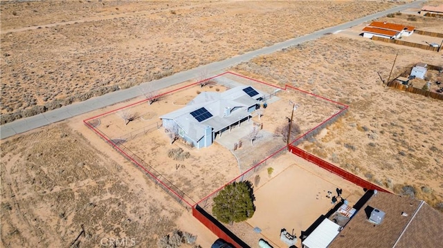 birds eye view of property with view of desert