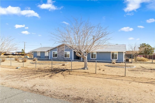 ranch-style house featuring a fenced front yard