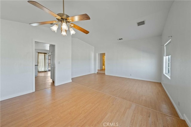 unfurnished room with ceiling fan, visible vents, baseboards, vaulted ceiling, and light wood-style floors