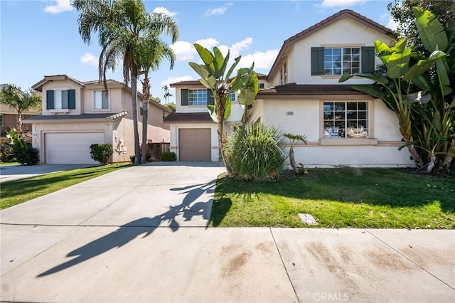 view of front of house with stucco siding, an attached garage, driveway, and a front lawn