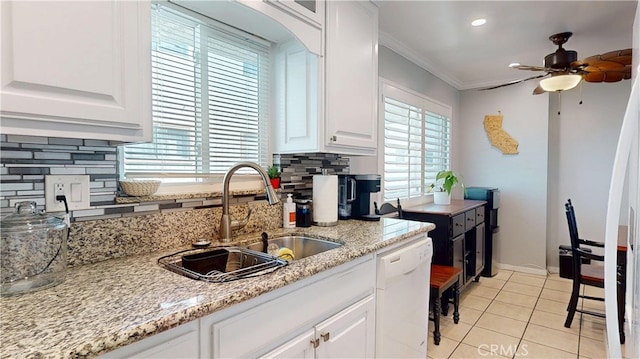 kitchen with light tile patterned floors, ornamental molding, white cabinetry, white dishwasher, and a sink