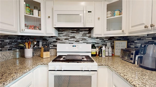 kitchen featuring white appliances, glass insert cabinets, backsplash, and white cabinetry