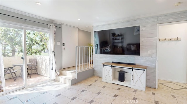 living area with crown molding and recessed lighting