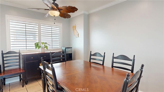 dining room with light tile patterned floors, a ceiling fan, and crown molding