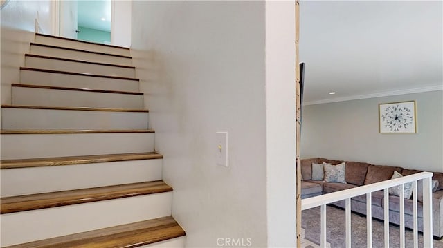 staircase featuring crown molding