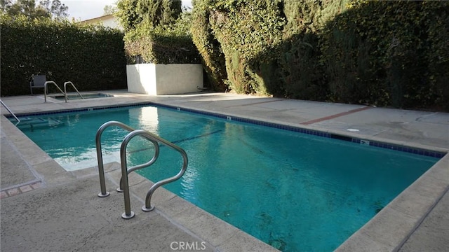 view of swimming pool with a patio area and a fenced in pool