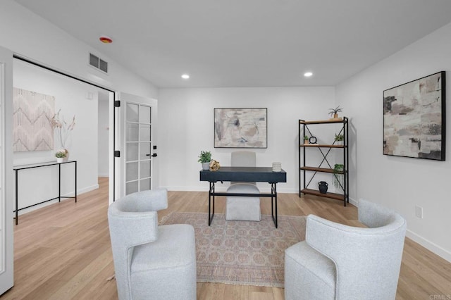 office area with baseboards, recessed lighting, visible vents, and light wood-style floors