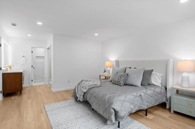 bedroom with recessed lighting, light wood-type flooring, connected bathroom, and baseboards