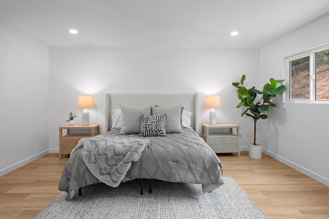 bedroom with recessed lighting, light wood-style flooring, and baseboards