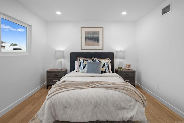 bedroom featuring recessed lighting, visible vents, baseboards, and wood finished floors