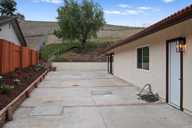 view of patio featuring fence