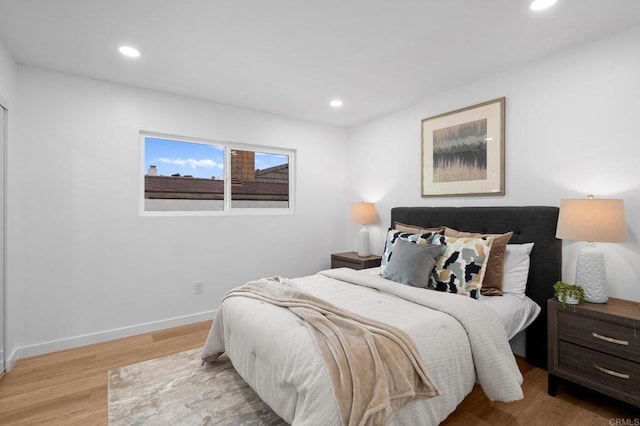 bedroom featuring light wood-type flooring, baseboards, and recessed lighting