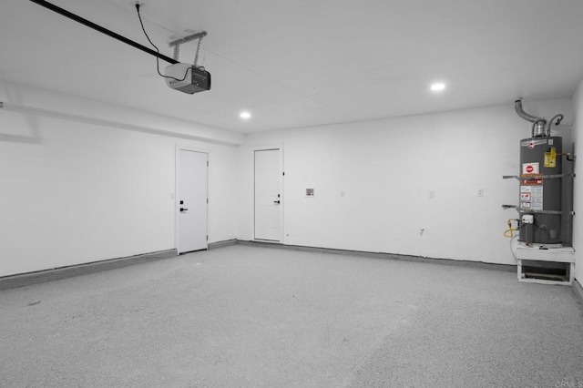 garage with a garage door opener, recessed lighting, and secured water heater