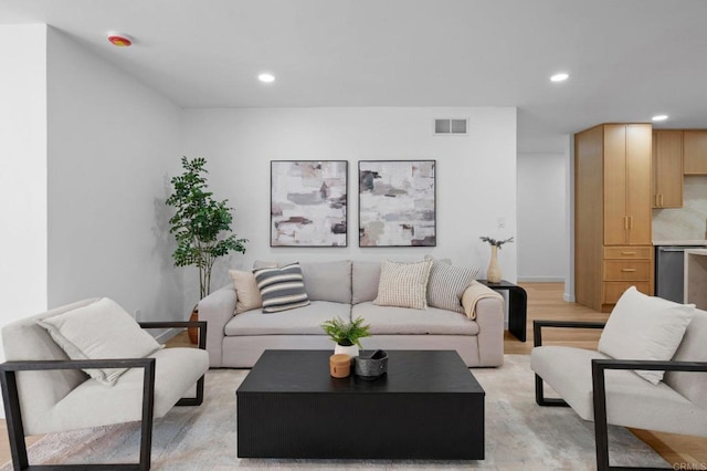 living area featuring light wood-type flooring, visible vents, and recessed lighting