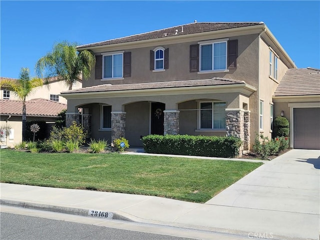 view of front of property with stucco siding, driveway, a tile roof, and a front yard