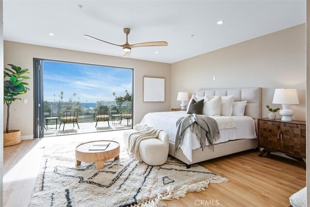 bedroom featuring baseboards, a ceiling fan, wood finished floors, access to outside, and recessed lighting