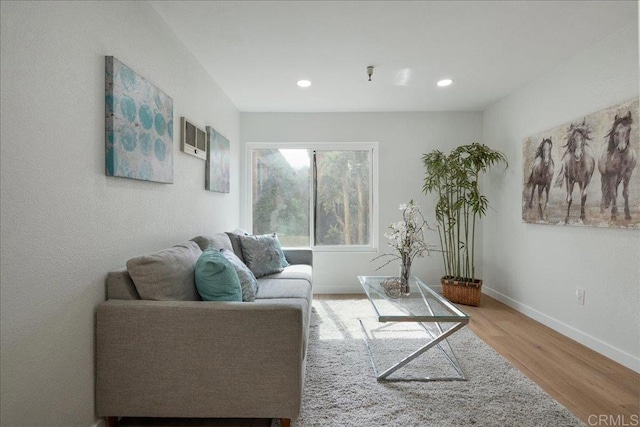 living room with recessed lighting, wood finished floors, visible vents, and baseboards