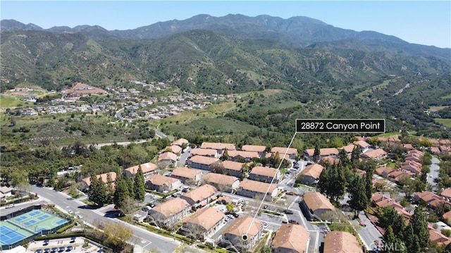 drone / aerial view featuring a residential view and a mountain view