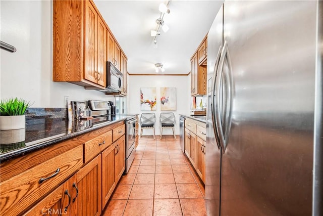 kitchen featuring stainless steel appliances, brown cabinetry, crown molding, and light tile patterned floors