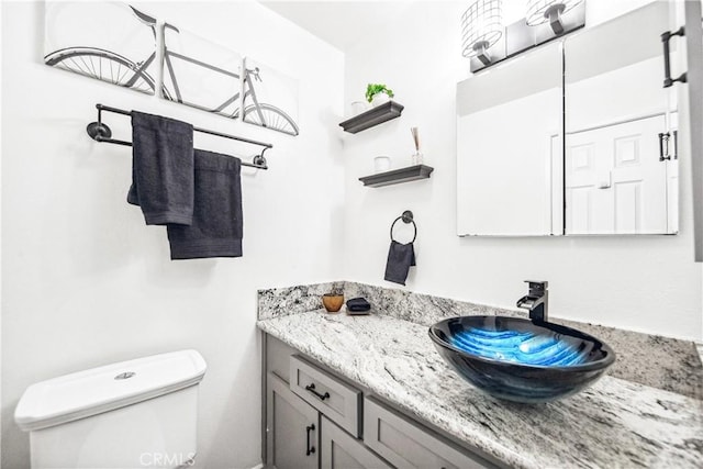 bathroom with toilet and vanity