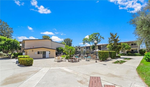 view of community featuring fence and a patio