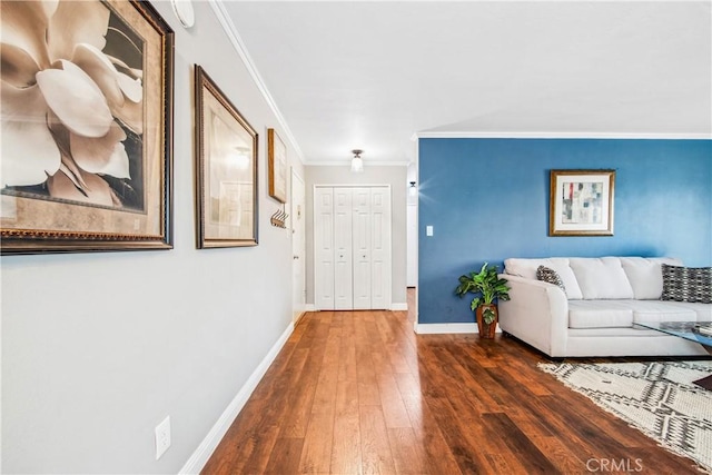 foyer featuring ornamental molding, baseboards, and hardwood / wood-style flooring