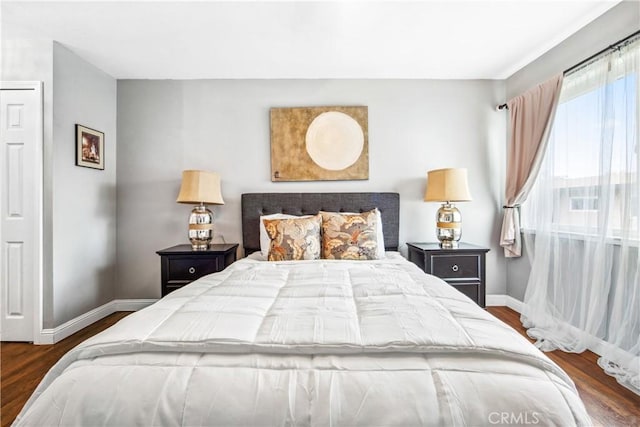 bedroom featuring baseboards and wood finished floors