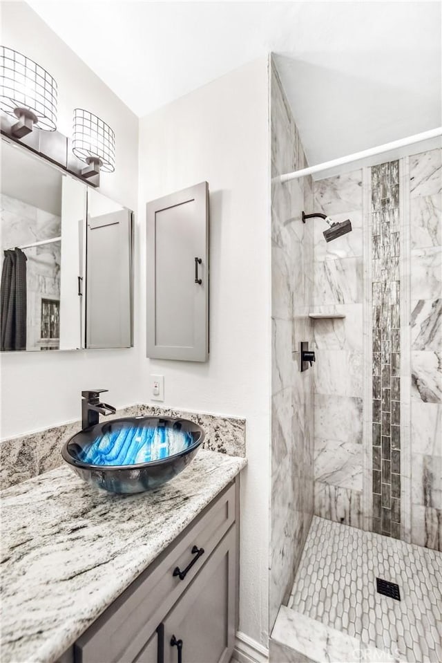 bathroom featuring a stall shower and vanity